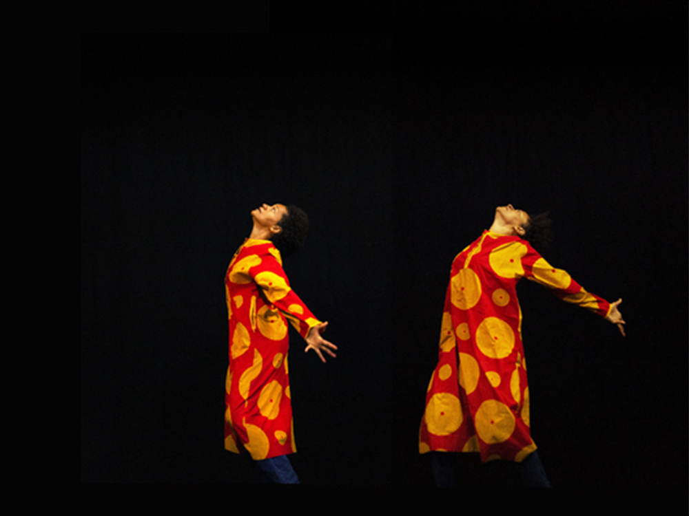 A dancer stretches their arms and extends their body towards the night sky. The figure is repeated twice in different poses. She is wearing a red and yellow dress
