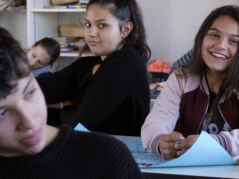 Happy kids sit in a classroom