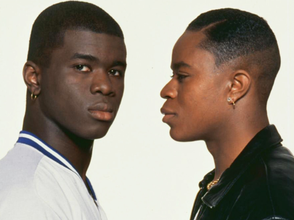 Portraits of two young black british men, in casual 70s clothing