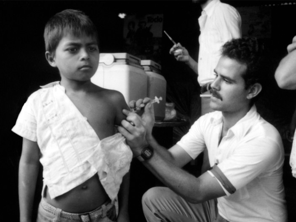 A young Nicaraguan boy is injected with a needle by a doctor