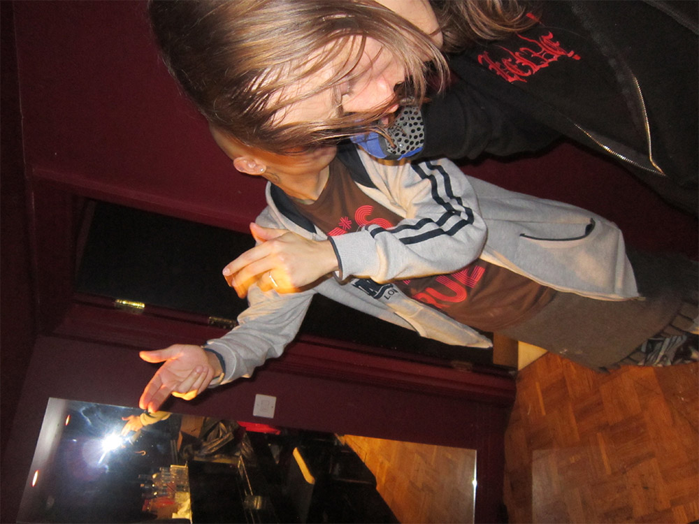 An obscured photo of the members of Platinum Blonde, making gun fingers