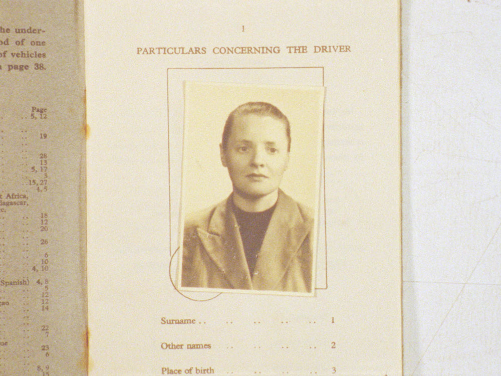 A person's portrait stuck to some kind of bureaucratic form, reading 'Particulars Concerning The Driver'